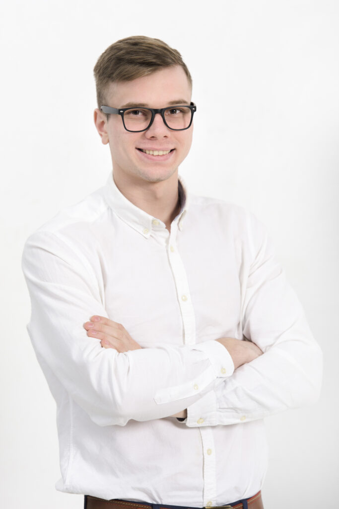 team-2 portrait young businessman with arms crossed looking camera isolated against white background